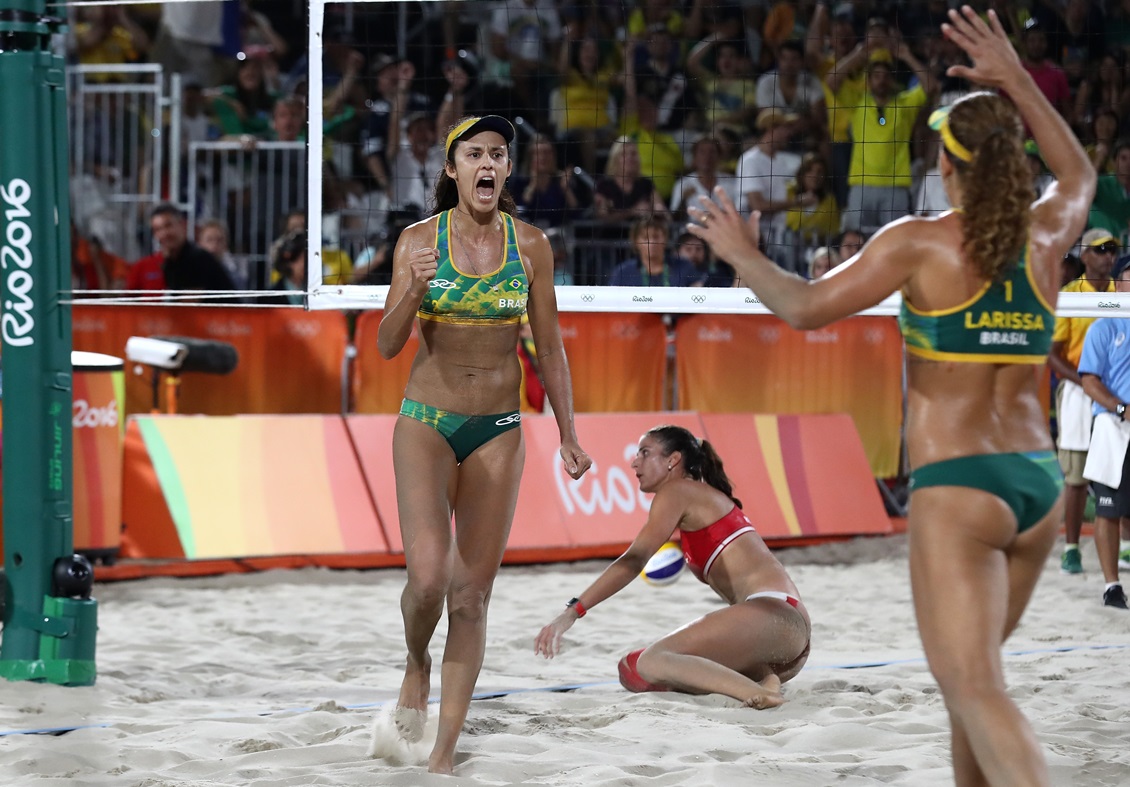 RIO DE JANEIRO, BRAZIL - AUGUST 14: Talita Rocha (L) of Brazil celebrates a point with teammate Larissa Franca Maestrini during a Women's Quarterfinal match between Brazil and Switzerland on Day 9 of the Rio 2016 Olympic Games at the Beach Volleyball Arena on August 14, 2016 in Rio de Janeiro, Brazil. (Photo by Sean M. Haffey/Getty Images)